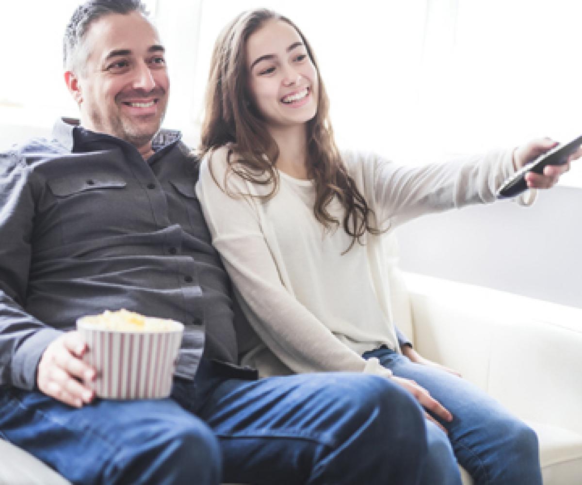 father and daughter watching TV